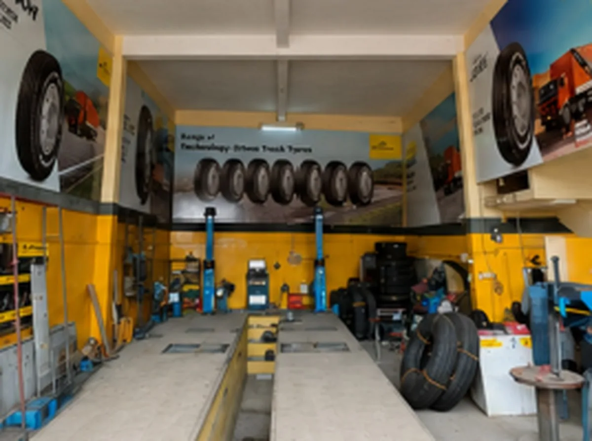 Truck tyre workshop bay with lifts and tyre changing equipment
